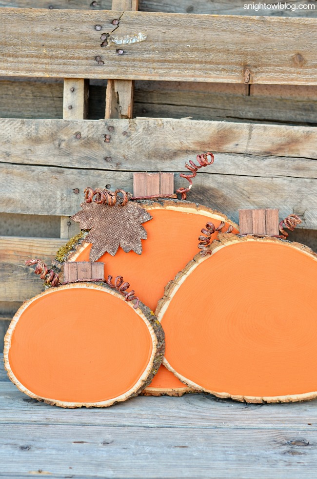 Add some color and whimsy to your Fall Decor with these easy and adorable Painted Wood Slice Pumpkins!