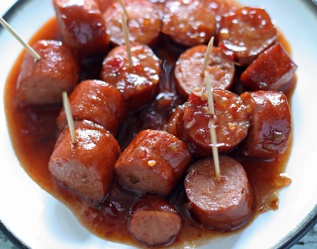 Our Slow Cooker Sweet Spicy Sausage is the perfect blend of sweet, spicy and smoky and is sure to be your new favorite appetizer!